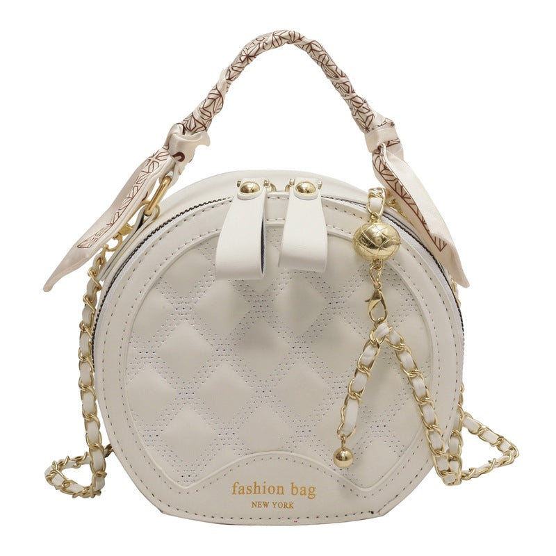 Petit sac rond brodé à motif losanges